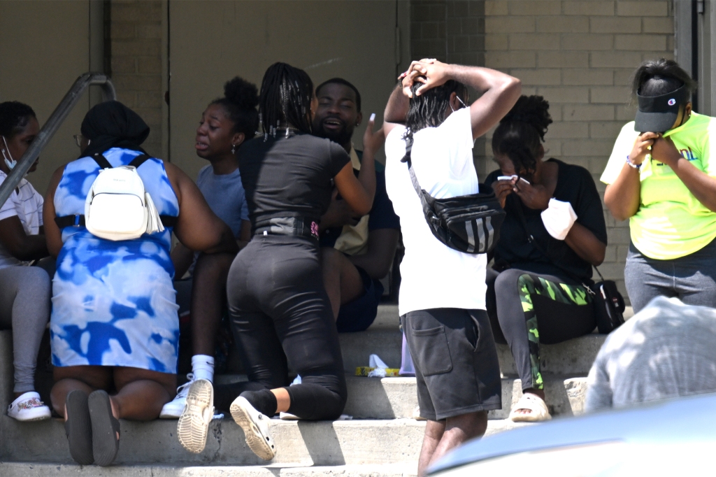 Relatives and friends of Matthew Jeremiah Webb are seen outside Brookdale Hospital as the victim remains in critical condition.