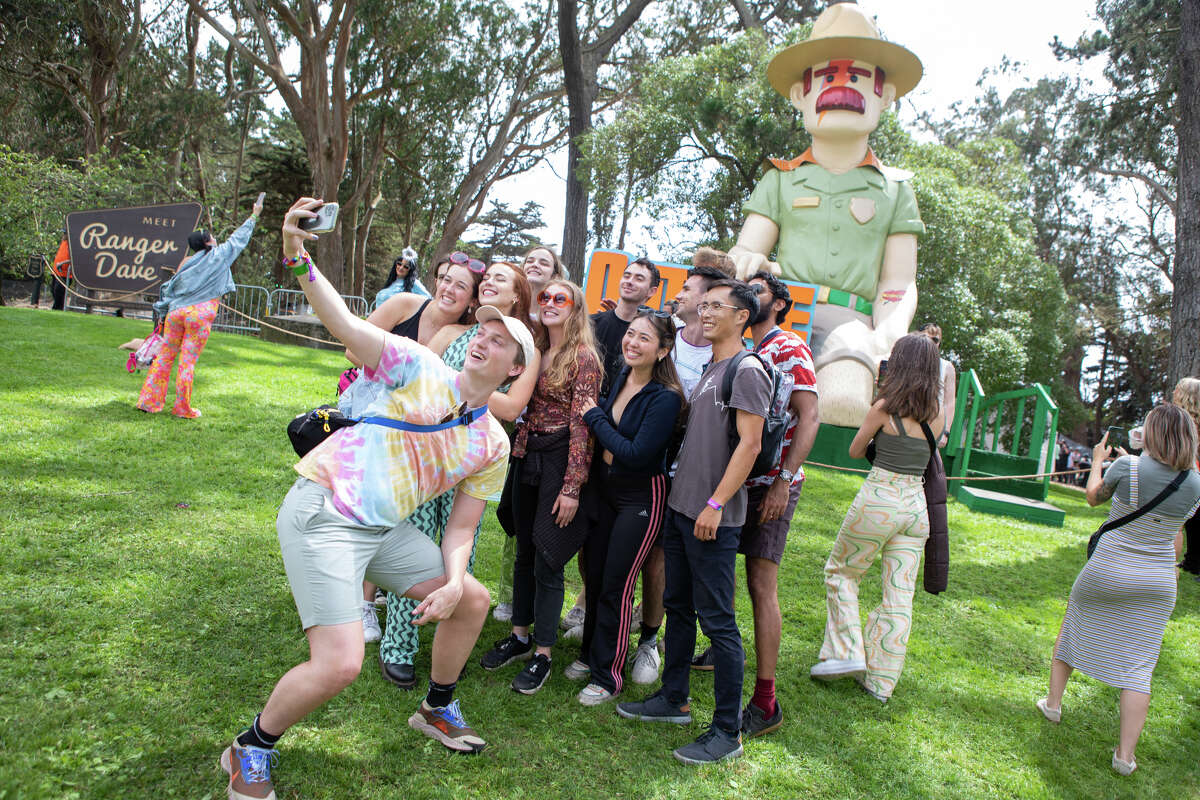 A group of fans pose for a photo at Outside Lands in Golden Gate Park in San Francisco, California on August 5, 2022.