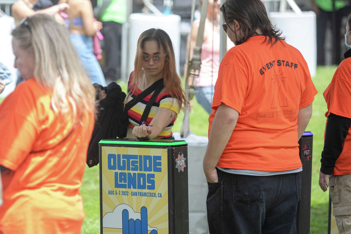 A festival-goer uses his badge to enter Outside Lands in Golden Gate Park in San Francisco, California on August 5, 2022.