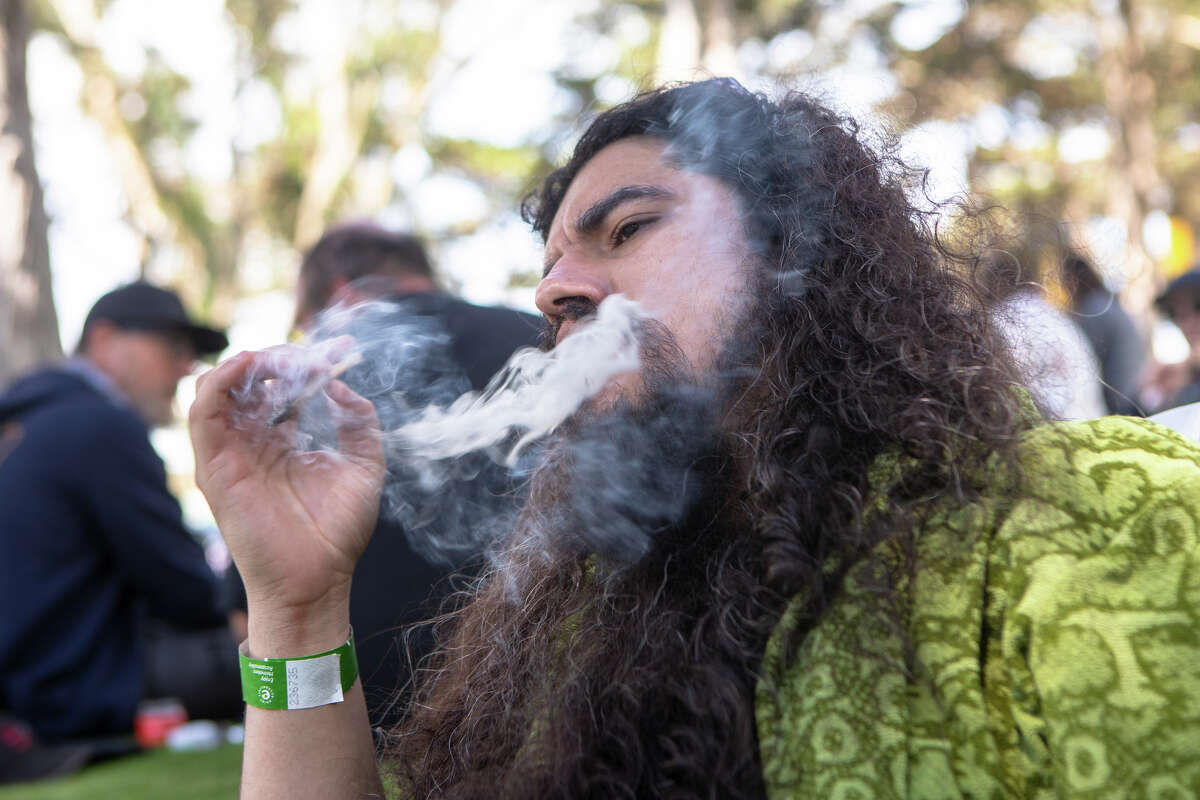 Kevin Alphonso takes a hit from a joint at GrassLands at Outside Lands in Golden Gate Park in San Francisco, Calif., on Aug. 5, 2022.