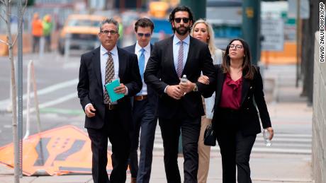 Defense investigator Lawrence Rudolph, left, walks into federal court in Denver with the dentist's children.