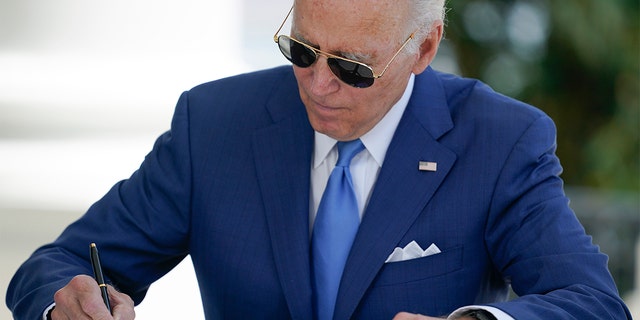 President Biden signs two bills aimed at combating fraud in COVID-19 small business relief programs Friday, August 5, 2022 at the White House in Washington.