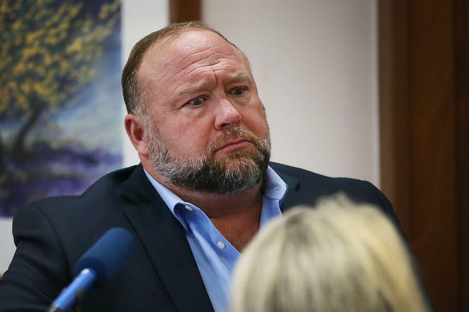 Alex Jones tries to answer questions about his emails posed by Mark Bankston, attorney for Neil Heslin and Scarlett Lewis, during the trial at the Travis County Courthouse on Wednesday August 3, 2022. Jones was found guilty of defamed the parents of a Sandy Hook student for calling the attack a hoax.